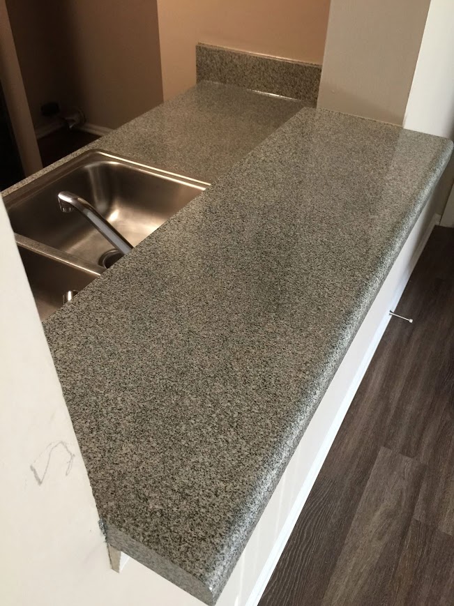 Refinished granite stone-look kitchen countertop after ANEW
