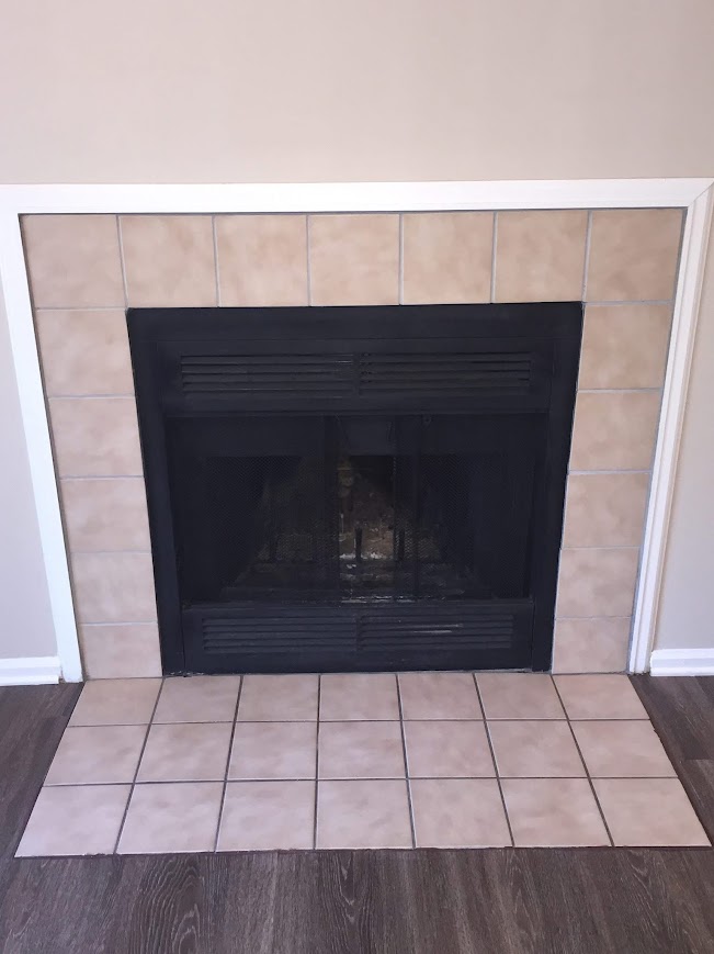 Dated beige tile fireplace before refinishing